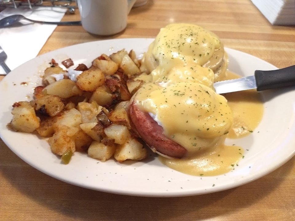Breakfast plates on a simple cafe table.