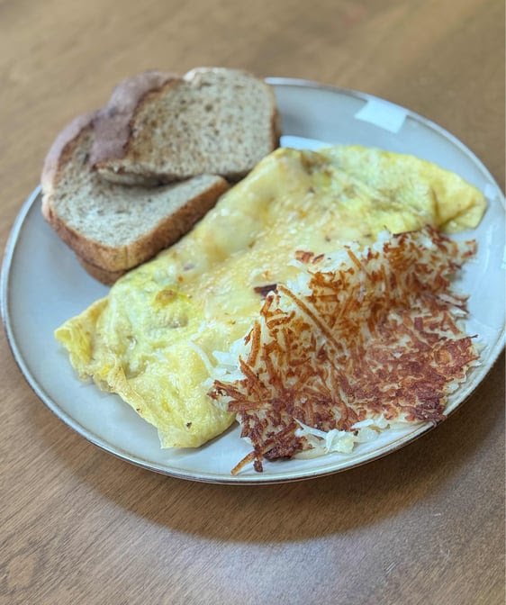 Breakfast plates on a simple cafe table.